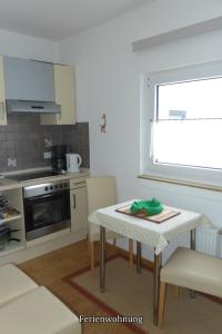 a small kitchen with a table and a window at Pension Haus Linden in Winterberg