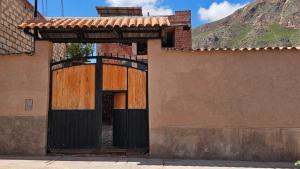 an entrance to a building with an open door at Hotel pumaexplorer in Urubamba