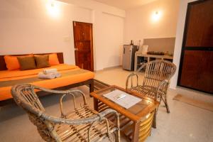 a living room with a bed and a table and chairs at Seraya Stays in Mandrem