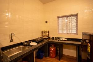 a kitchen with a sink and a counter top at Seraya Stays in Mandrem +84 photos