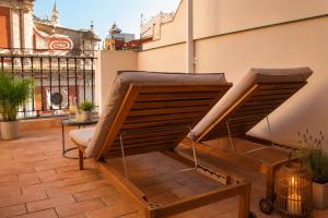 a balcony with a bench and a table at Panther Home Salvador in Seville