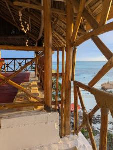 a view of the ocean from a beach house at Nisandra Beach Hotel in Nungwi