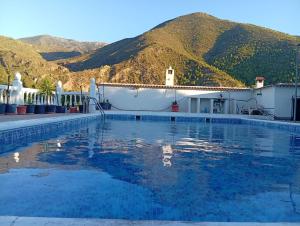 a swimming pool with mountains in the background at Casa Aguas Claras in Órgiva