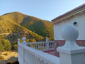 a balcony of a house with a mountain in the background at Casa Aguas Claras in Órgiva