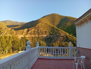 a white balcony with a view of a mountain at Casa Aguas Claras in Órgiva