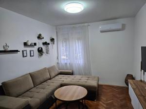 a living room with a couch and a table at Luxury Apartment Lara Mostar in Mostar