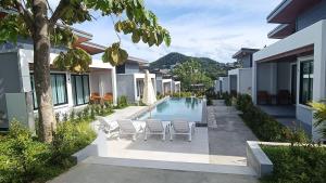 a courtyard with chairs and a swimming pool at Green Mountain View villas Koh samui in Plai Laem