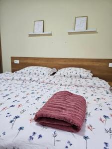 a bed with a red blanket on top of it at Luxury Apartment Lara Mostar in Mostar