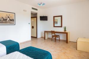 ein Hotelzimmer mit Bett und Schreibtisch in der Unterkunft Baglio Basile - CDSHotels in Petrosino