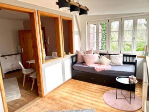 a living room with a couch and a table at Idyllische Auszeit am Waldrand in Weiler