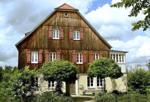 a large wooden barn with a bench in front of it at Idyllische Auszeit am Waldrand in Weiler +11 photos
