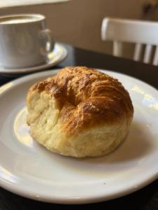 a doughnut sitting on a white plate on a table at Posada Las Chacras in Ciudad Lujan de Cuyo