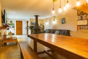 a living room with a wooden table and a couch at Les Combes Claires in Saint-Julien-Labrousse