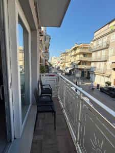two chairs sitting on a balcony with a view of a street at Casa sissy in Chioggia