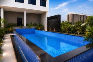 a swimming pool on the roof of a house at Pride Plaza Indore in Indore