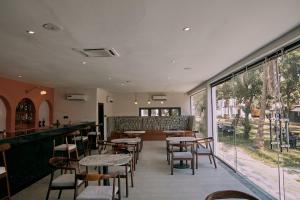 a restaurant with tables and chairs and a bar at SeaLord Resort in Abuja