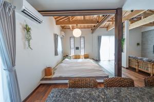 a large room with a bed in the middle of it at Villa Arco Miyakojima in Miyako-jima +56 photos