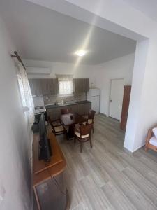 a kitchen and dining room with a table and chairs at Paulos&Mary Apartment in Flogita