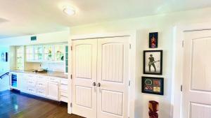 a kitchen with white cabinets and a counter top at Kaanapali's Royal Luxury Plantation Beach & Golf Retreat in Kaanapali +115 photos