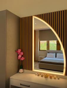 a bedroom with a bed and a large mirror at Castle View in Qeparo