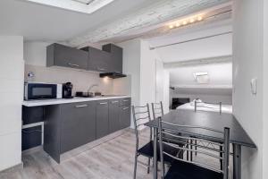 a kitchen and dining room with a table and a microwave at Studio Centre Cannes, Rue d’Antibes in Cannes