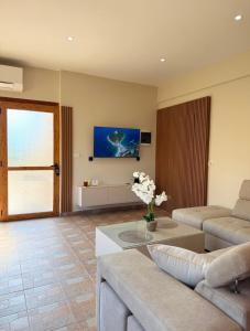 a living room with a couch and a table at Castle View in Qeparo