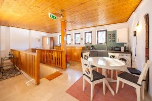 a kitchen and dining room with a table and chairs at Café Marie - Bed & Breakfast in Eggersdorf bei Graz +71 photos