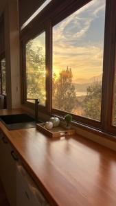 a kitchen counter with a large window with a view at Castle View in Qeparo