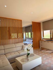a living room with a couch and a table at Castle View in Qeparo +1 photo