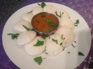 a plate of food with a bowl of soup at Hotel Sai Praatham in Shirdi