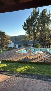 a bench sitting on a deck next to a pool at Quinta Ecuador Tandil in Tandil