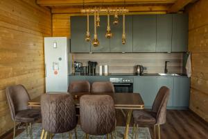 a kitchen with a dining room table and chairs at Golden view Villa in Prishtinë