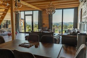 a living room with a table and chairs at Golden view Villa in Prishtinë