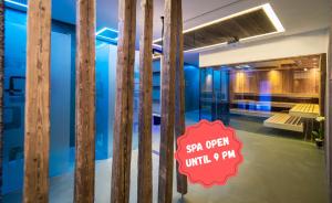 a room with a sign that reads spa open until at Hotel COSMEA - Your Dolomites & Honeymoon experience in Ortisei