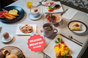 a table full of breakfast foods and drinks at Hotel COSMEA - Your Dolomites & Honeymoon experience in Ortisei