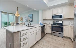 a kitchen with a sink and a stove top oven at Phoenix Gulf Towers 706 condo in Gulf Shores
