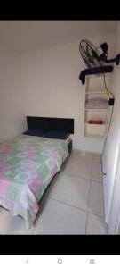 a bedroom with a bed and a chair on a shelf at Hostel Viracopos in Campinas