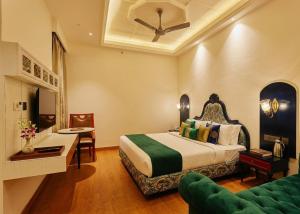 a hotel room with a bed and a couch at Hotel Pacific Primee in Zirakpur +125 photos