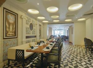 a long dining room with a long table and chairs at Hotel Pacific Primee in Zirakpur