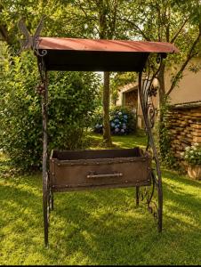 an old iron bench sitting in the grass at Солочин Квітка Полонини Дом 63 in Solochyn