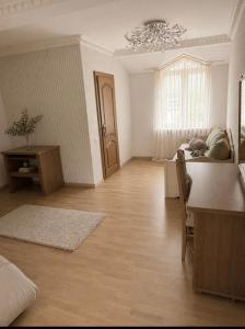 a living room with a table and a dining room at Солочин Квітка Полонини Дом 63 in Solochyn