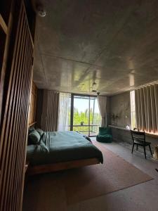 a bedroom with a large bed and a window at Chum Home in Thanh Ðông (1)