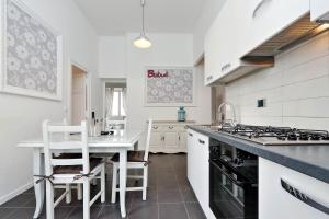a kitchen with white appliances and a white counter top at Charming Apartment Antonia 300 mt from Colosseum in Rome