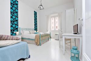 a bedroom with two beds and a desk with a computer at Charming Apartment Antonia 300 mt from Colosseum in Rome