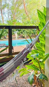 a stack of umbrellas sitting on a porch at Hotel Pousada Capão in Garopaba