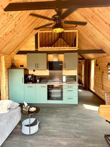 a kitchen with blue cabinets and a ceiling at Chalet Muckelstübchen in Bad Arolsen