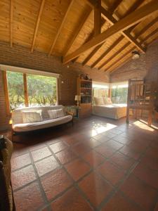 a large room with two beds and a wooden ceiling at Quinta Ecuador Tandil in Tandil +37 photos