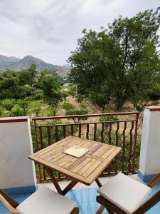 a wooden table and two chairs on a balcony at The Citrus Balcony in Trappitello