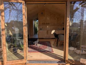 a room with a large glass door of a house at Bakkums Bosgeluk in Castricum