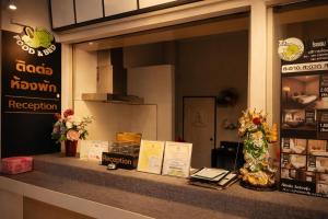a display window of a restaurant with flowers and books at 777 Food & Bed in Chiang Rai